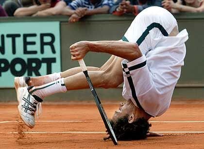 tennis play falling on head in a comedic fashion
